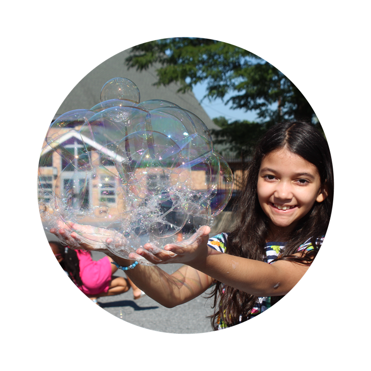 child girl holding large bubble